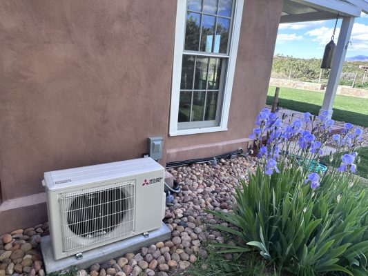 AC installation by flower bed